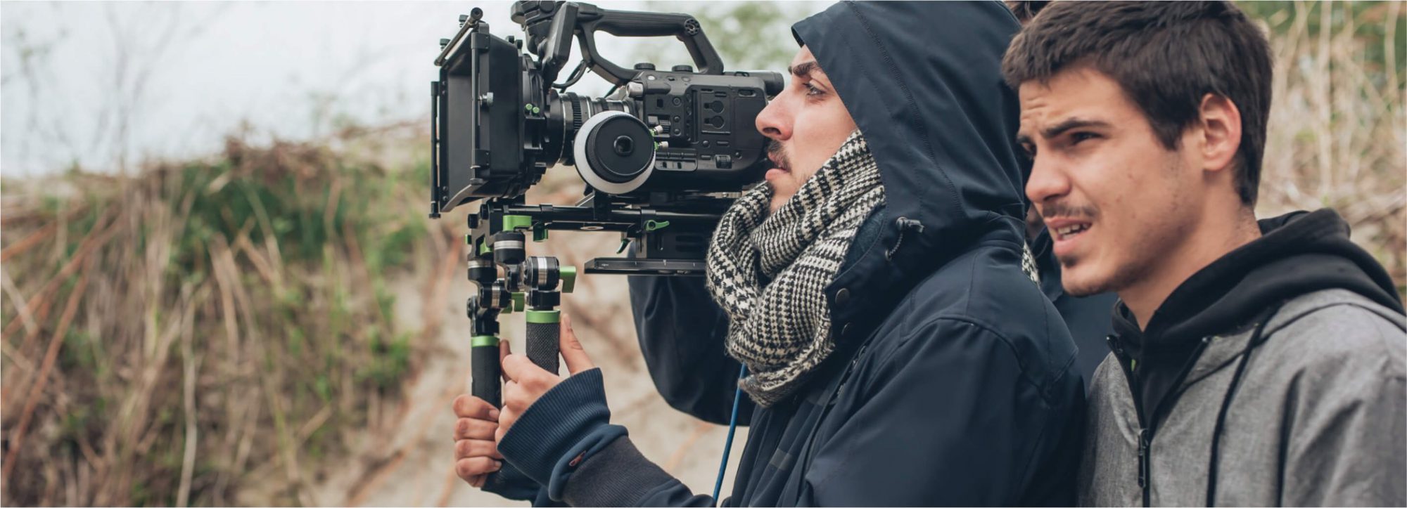 Cameraman and director in the field, engaged in photo shoot