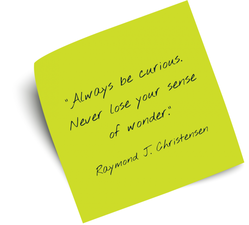 Post-it note that reads: Always be curious. Never lose your sense of wonder. Raymond J Christensen